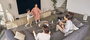 Family enjoying music from a variety of different sitting and standing positions in the room